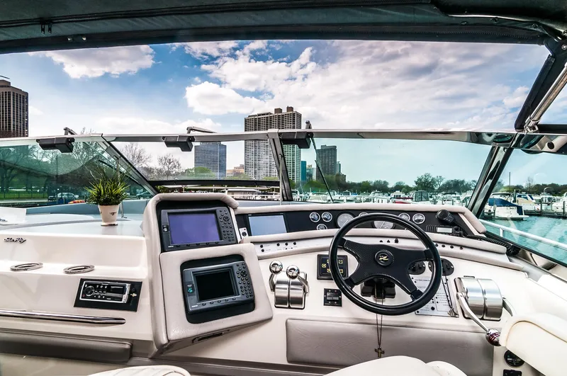 Slide: The Image of 1994 Sea Ray 500 Sundancer yacht helm with city skyline view - 6