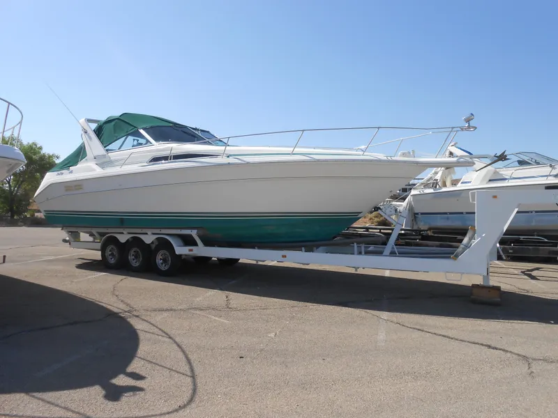 Slide: The Image of 1991 Sea Ray Sundancer 310 on trailer in marina. - 0