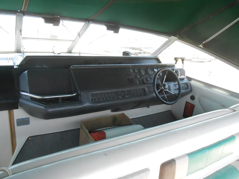Slide: The Image of 1991 Sea Ray Sundancer 310 boat cockpit with steering wheel and control panel. - 3