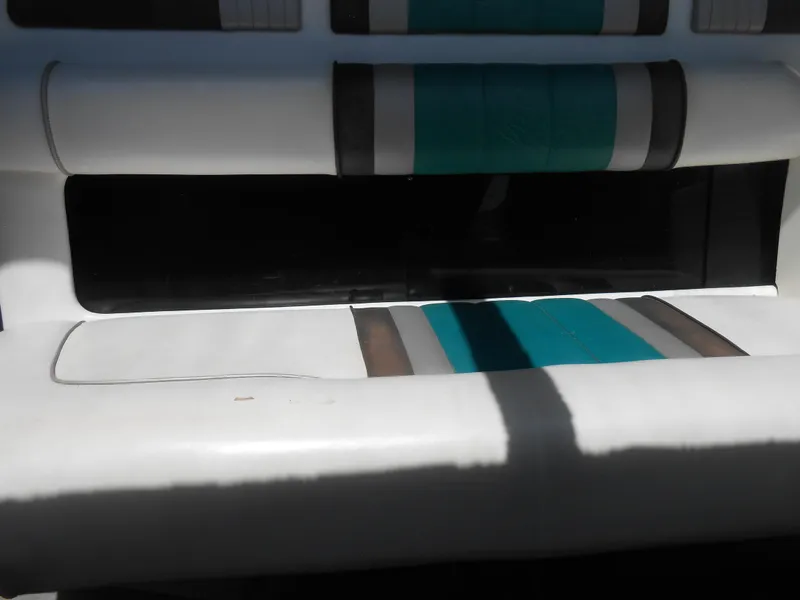Slide: The Image of Sea Ray Sundancer 310 1991 boat interior seating with teal and gray accents. - 4