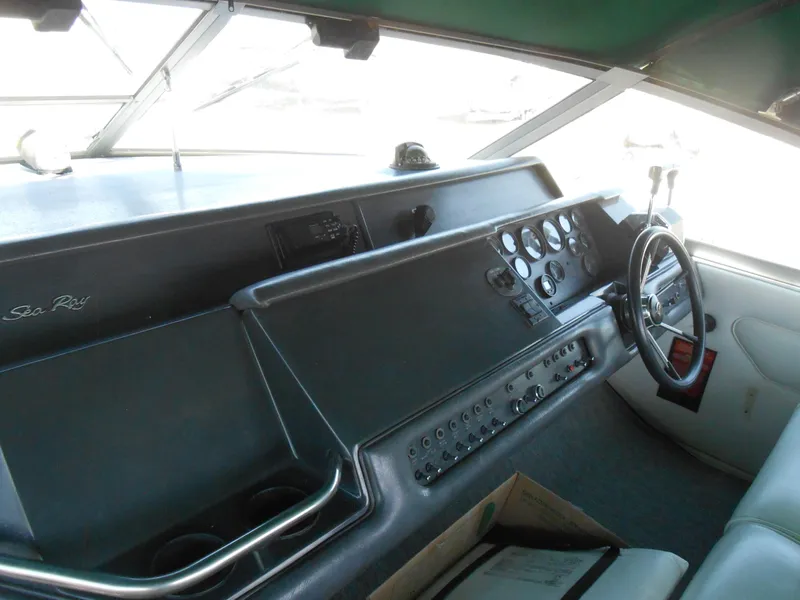Slide: The Image of 1991 Sea Ray Sundancer 310 boat dashboard with steering wheel and control panel. - 5