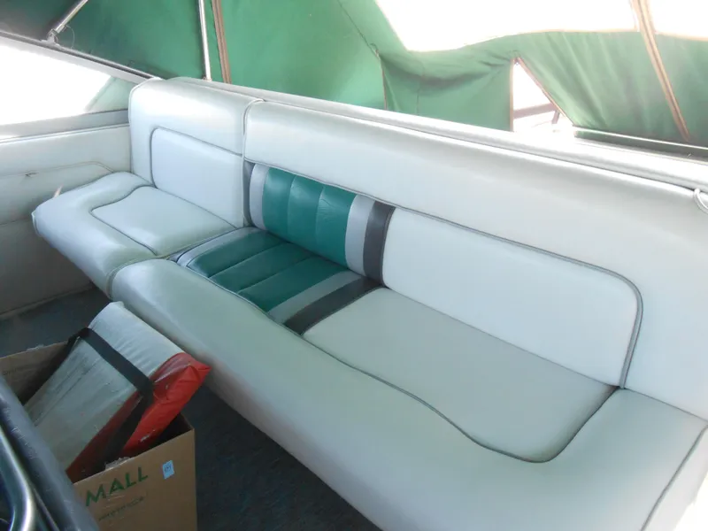 Slide: The Image of 1991 Sea Ray Sundancer 310 interior seating with green and white upholstery. - 7