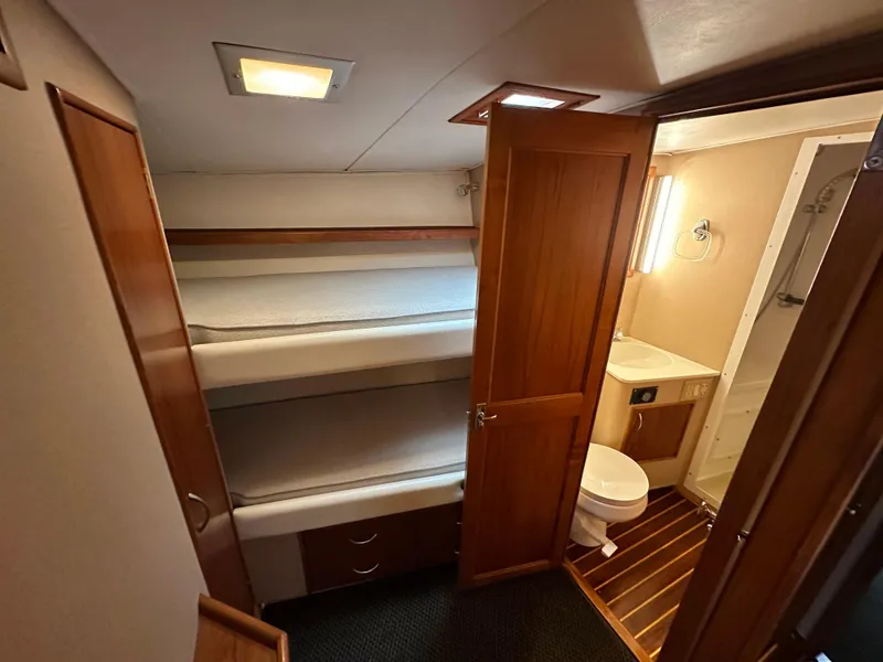 Slide: The Image of Interior of 1991 Buddy Davis Convertible yacht with leather seating and wooden cabinetry. - 13