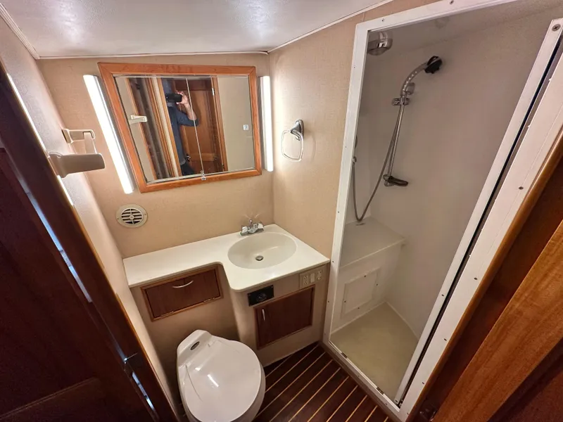 Slide: The Image of 1991 Buddy Davis Convertible yacht interior with wooden finishes and leather seating. - 14