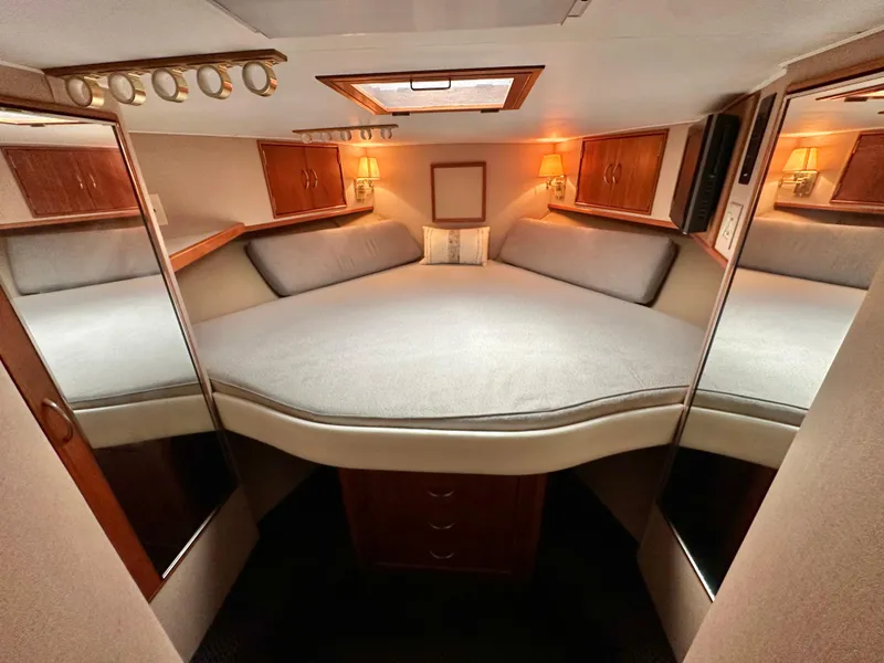 Slide: The Image of 1991 Buddy Davis Convertible yacht kitchen with wooden cabinetry and stainless steel appliances. - 15