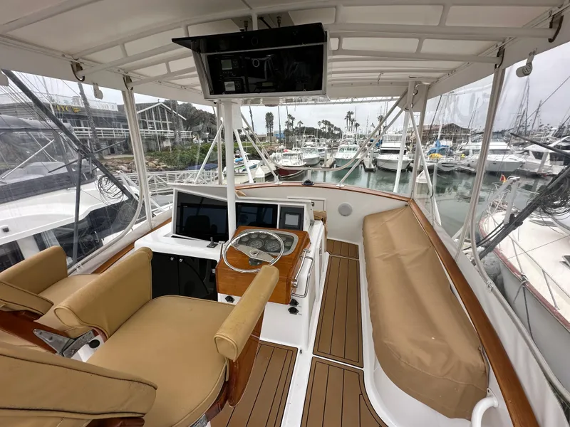 Slide: The Image of 1991 Buddy Davis Convertible yacht kitchen with wooden cabinets and stainless steel appliances. - 16