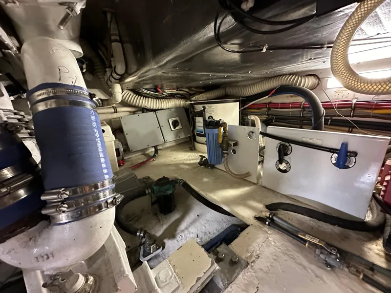 Slide: The Image of Engine room of a 1991 Buddy Davis Convertible boat showing various mechanical components. - 25