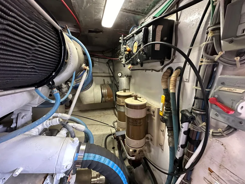 Slide: The Image of Engine room of a 1991 Buddy Davis Convertible boat with various mechanical components. - 27