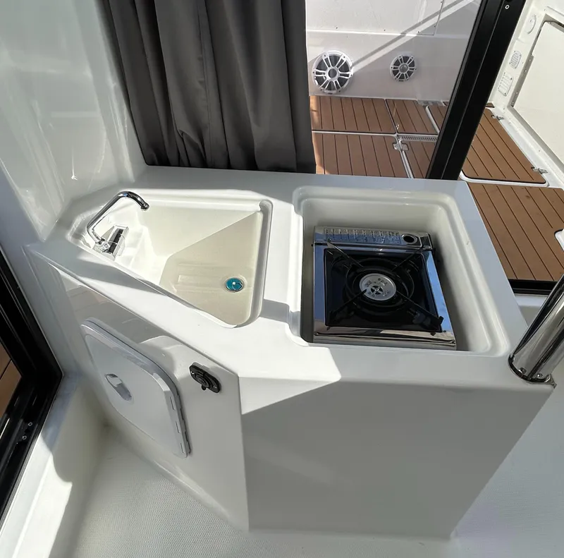Slide: The Image of Compact kitchenette in 2024 Parker Poland 800 Pilothouse boat with sink and stove. - 10