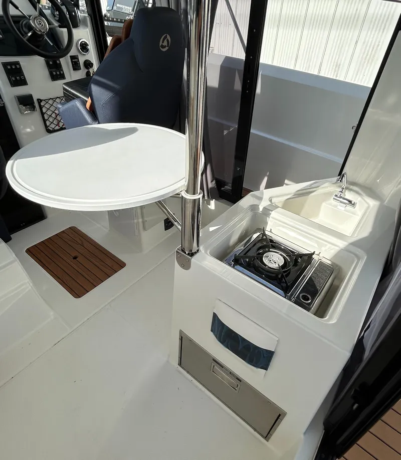 Slide: The Image of 2024 Parker Poland 800 Pilothouse interior with compact kitchen and seating area. - 11