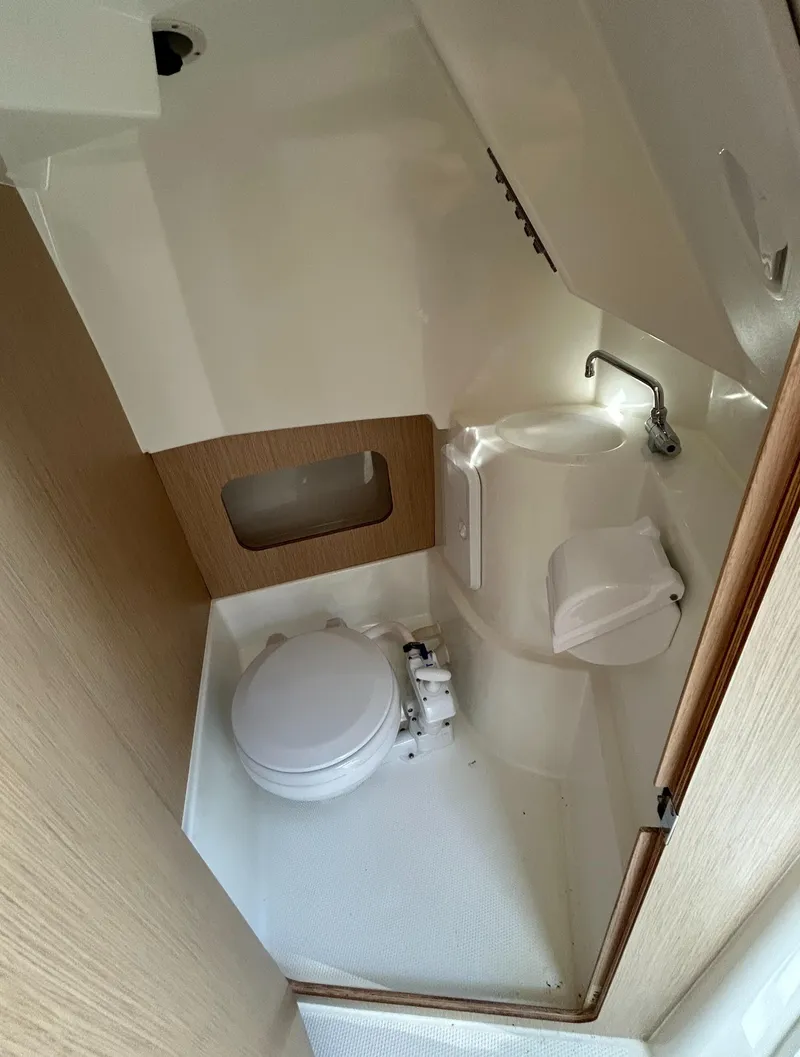 Slide: The Image of 2024 Parker Poland 800 Pilothouse boat bathroom interior with toilet and sink. - 13