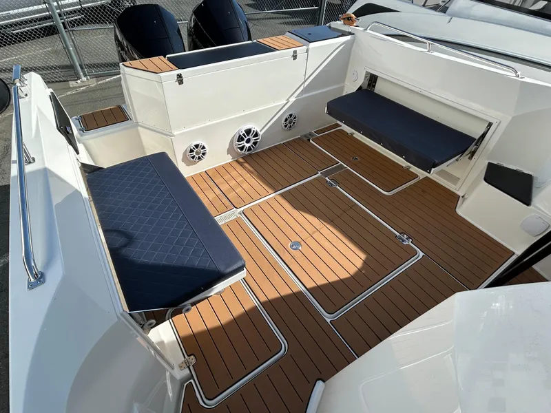 Slide: The Image of 2024 Parker Poland 800 Pilothouse boat interior with teak flooring and cushioned seating. - 14