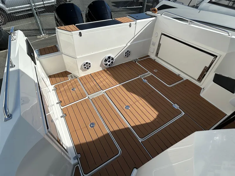 Slide: The Image of 2024 Parker Poland 800 Pilothouse boat deck with wood finish and storage compartments. - 15