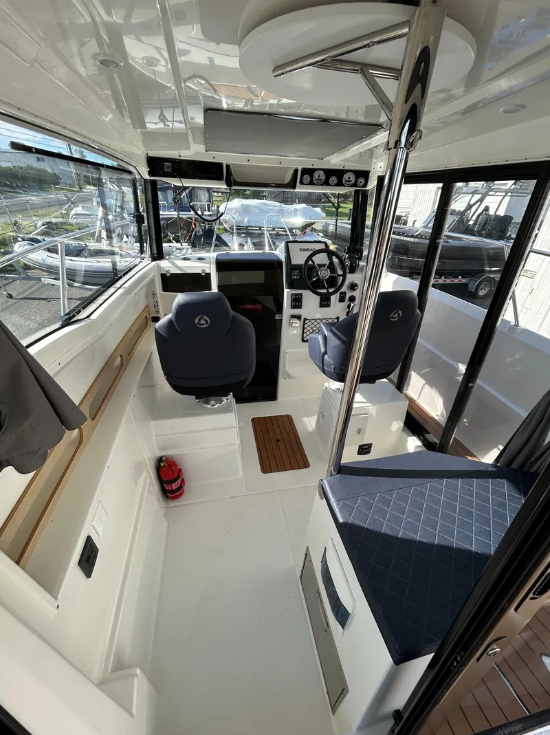 Slide: The Image of 2024 Parker Poland 800 Pilothouse interior with modern helm and seating. - 6