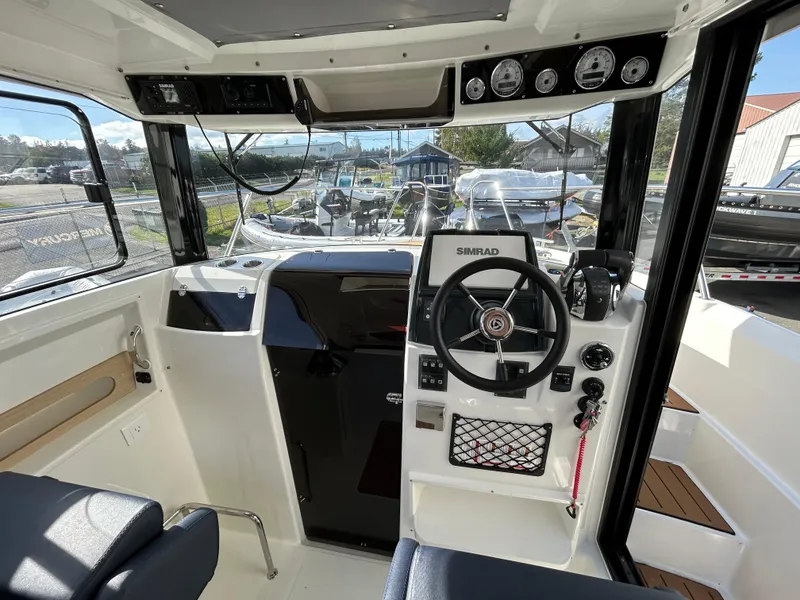 Slide: The Image of 2024 Parker Poland 800 Pilothouse interior with steering wheel and navigation equipment. - 7