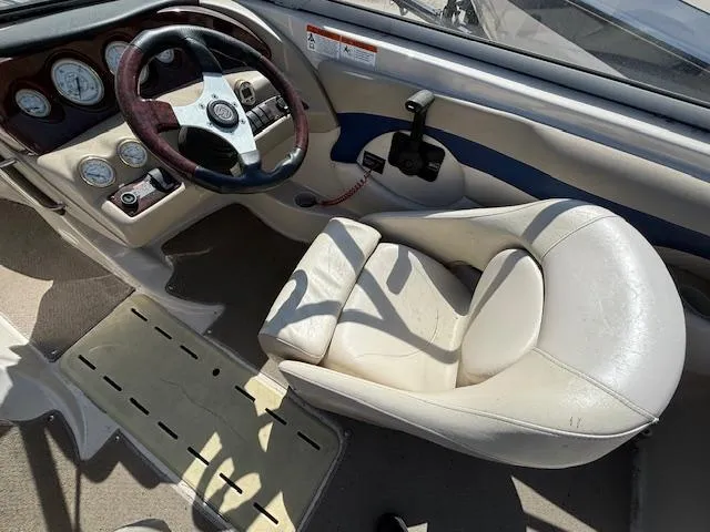 Slide: The Image of 2004 Glastron GX 185 boat interior with steering wheel and captain's seat. - 10