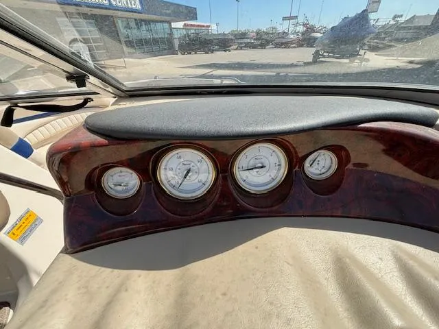 Slide: The Image of Dashboard of a 2004 Glastron GX 185 boat with gauges and controls. - 14