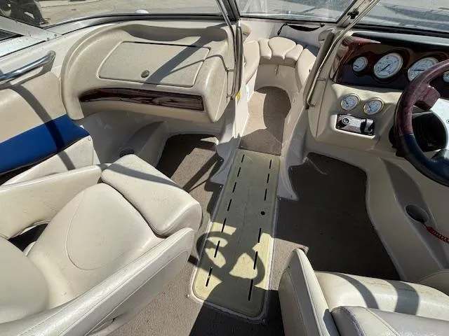 Slide: The Image of Interior of a 2004 Glastron GX 185 boat with beige seating and dashboard. - 16