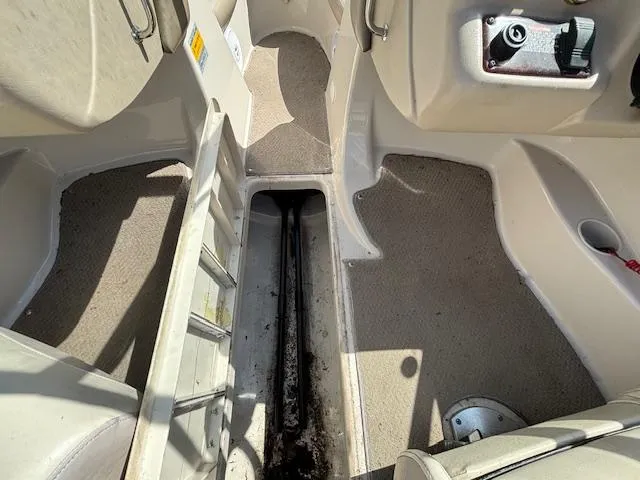 Slide: The Image of Interior of a 2004 Glastron GX 185 boat showing storage compartment and seating area. - 18