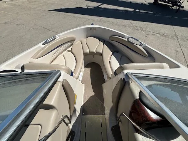 Slide: The Image of 2004 Glastron GX 185 boat interior with beige seating and open bow design. - 19