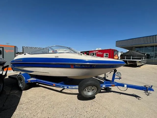 Slide: The Image of 2004 Glastron GX 185 boat on a trailer in a parking lot. - 4