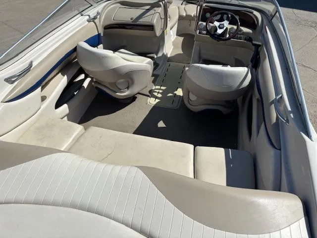 Slide: The Image of Interior of a 2004 Glastron GX 185 boat with beige and white seating. - 7