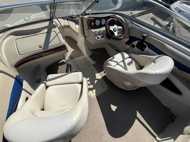 Slide: The Image of 2004 Glastron GX 185 boat interior with beige seats and dashboard. - 9