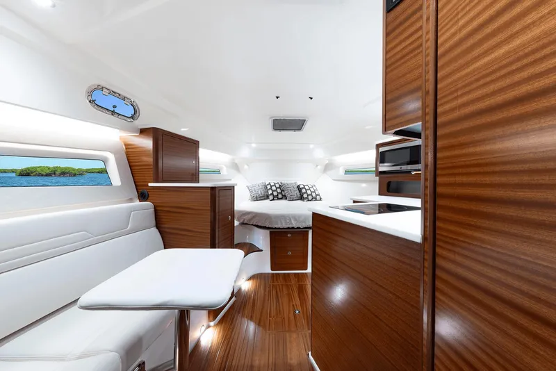 Slide: The Image of Luxurious interior of 2025 Pursuit OS 405 yacht with modern wood finishes and cozy seating. - 10