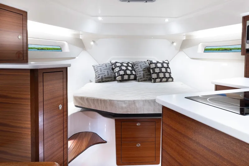 Slide: The Image of Luxurious cabin interior of 2025 Pursuit OS 405 boat with modern wood finishes. - 11