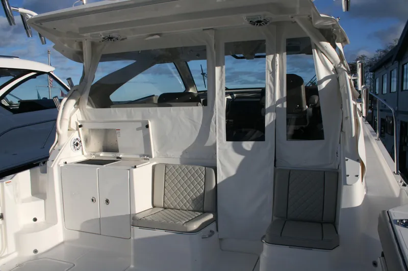 Slide: The Image of 2025 Pursuit OS 405 Offshore boat interior with seating and storage compartments. - 14