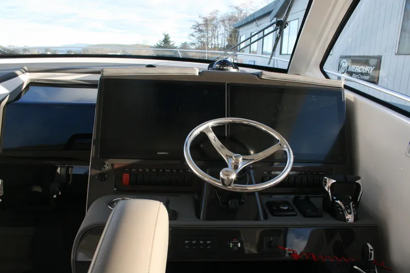 Slide: The Image of Helm of 2025 Pursuit OS 405 Offshore boat with modern controls and navigation screens. - 17