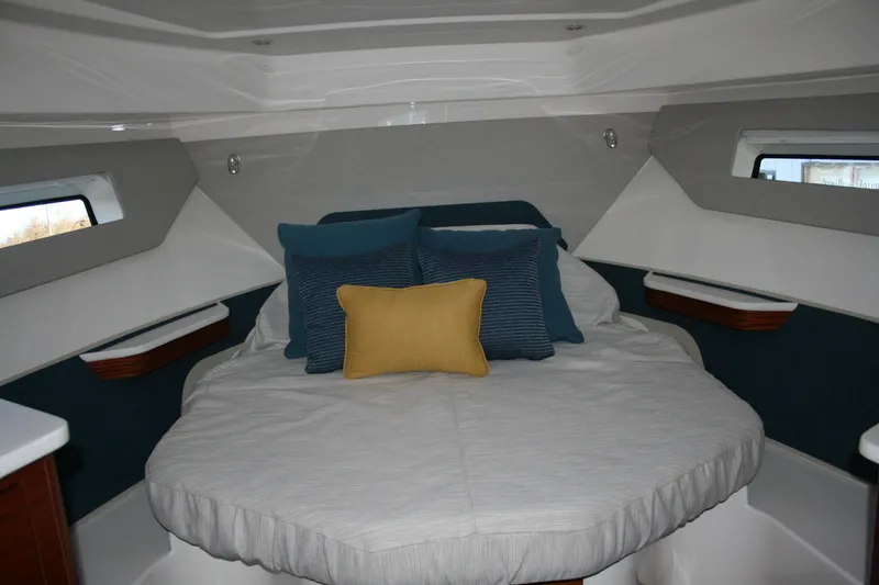 Slide: The Image of Luxurious cabin interior of 2025 Pursuit OS 405 Offshore boat with plush bedding. - 19