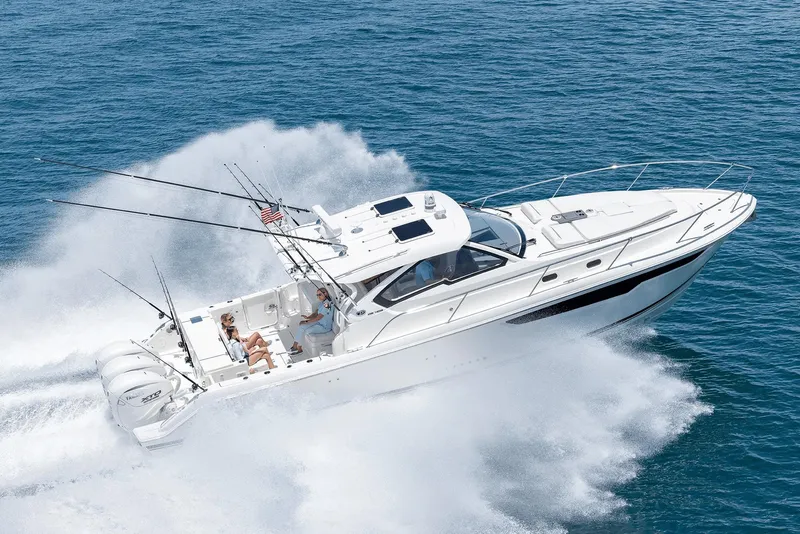 Slide: The Image of 2025 Pursuit OS 405 boat cruising swiftly on open water. - 2