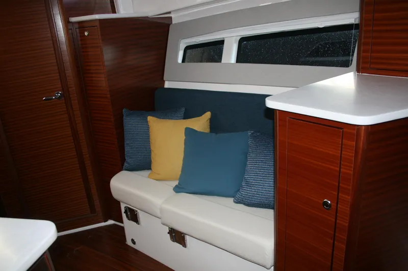 Slide: The Image of Interior of 2025 Pursuit OS 405 Offshore boat with cozy seating and colorful cushions. - 21