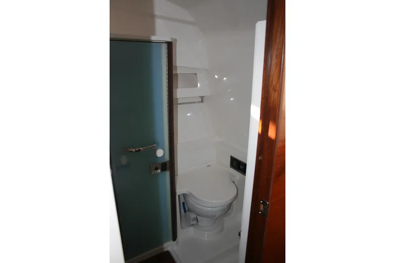 Slide: The Image of 2025 Pursuit OS 405 Offshore boat bathroom with modern fixtures and compact design. - 23