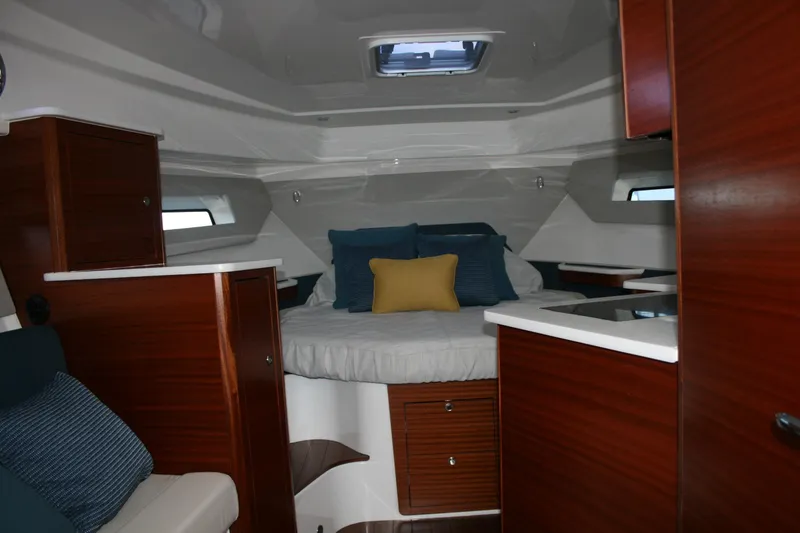 Slide: The Image of Luxurious cabin interior of 2025 Pursuit OS 405 Offshore boat with cozy bedding. - 27