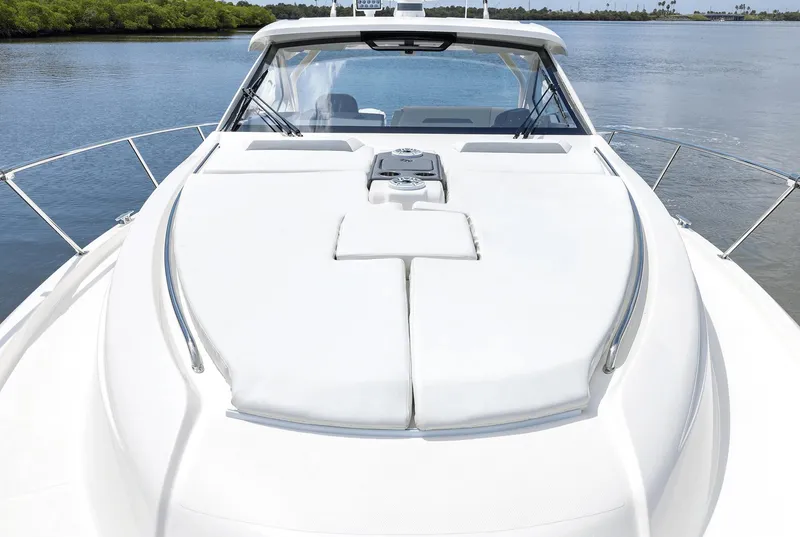 Slide: The Image of 2025 Pursuit OS 405 boat on calm water, showcasing sleek design and spacious deck. - 6