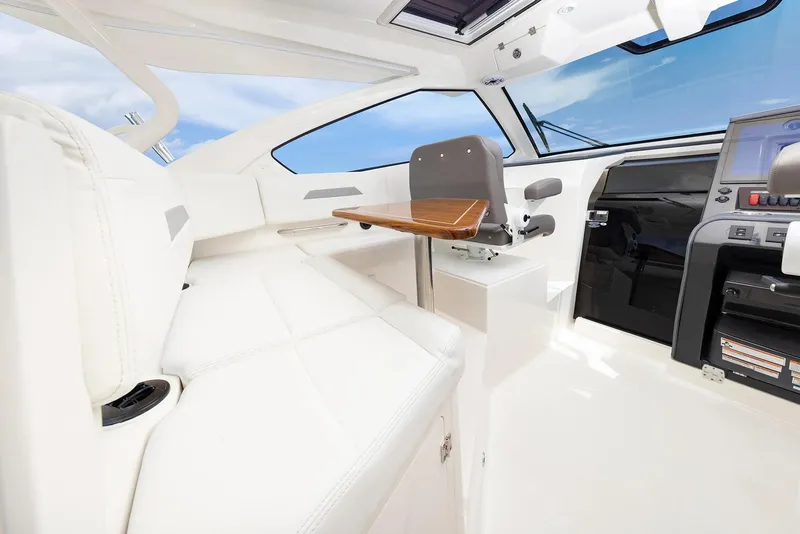 Slide: The Image of Luxurious interior of 2025 Pursuit OS 405 boat with white seating and modern controls. - 8