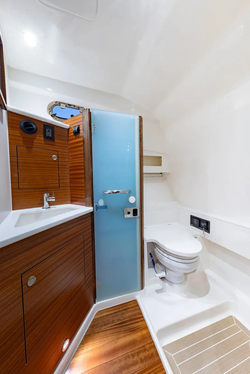 Slide: The Image of 2025 Pursuit OS 405 yacht bathroom with wooden cabinetry and modern fixtures. - 9