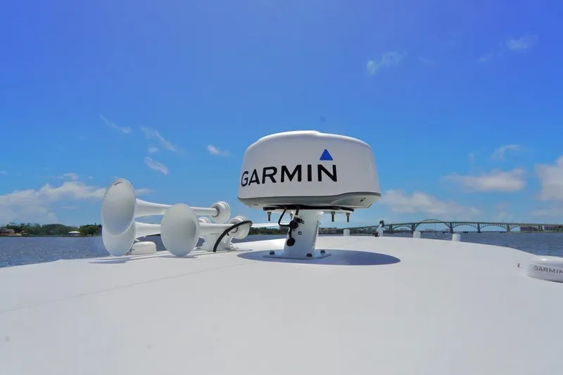 Slide: The Image of Garmin radar on 1993 Ocean Runner 27 CC boat under clear blue sky. - 12