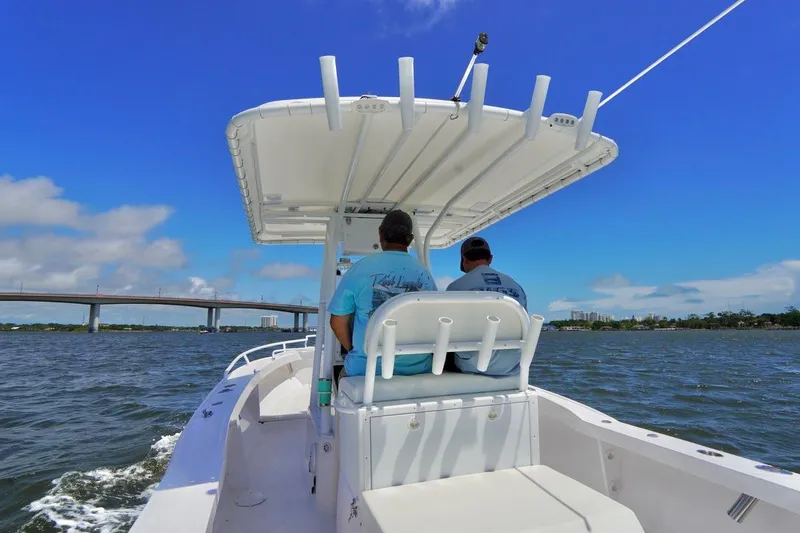 Slide: The Image of Two people on a 1993 Ocean Runner 27 CC boat cruising on a sunny day. - 14