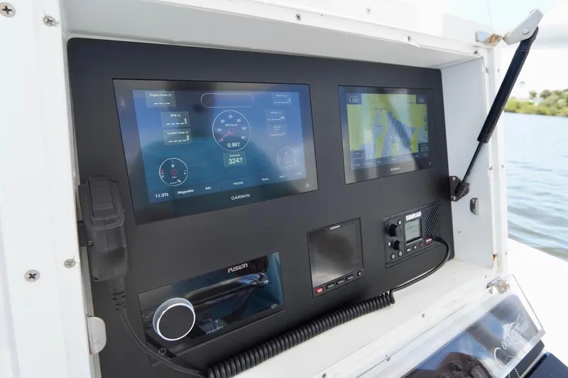 Slide: The Image of Control panel of a 1993 Ocean Runner 27 CC boat with modern navigation equipment. - 15