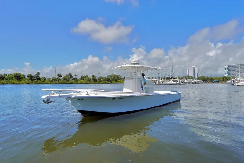 Slide: The Image of 1993 Ocean Runner 27 CC boat on calm water with a clear blue sky. - 2