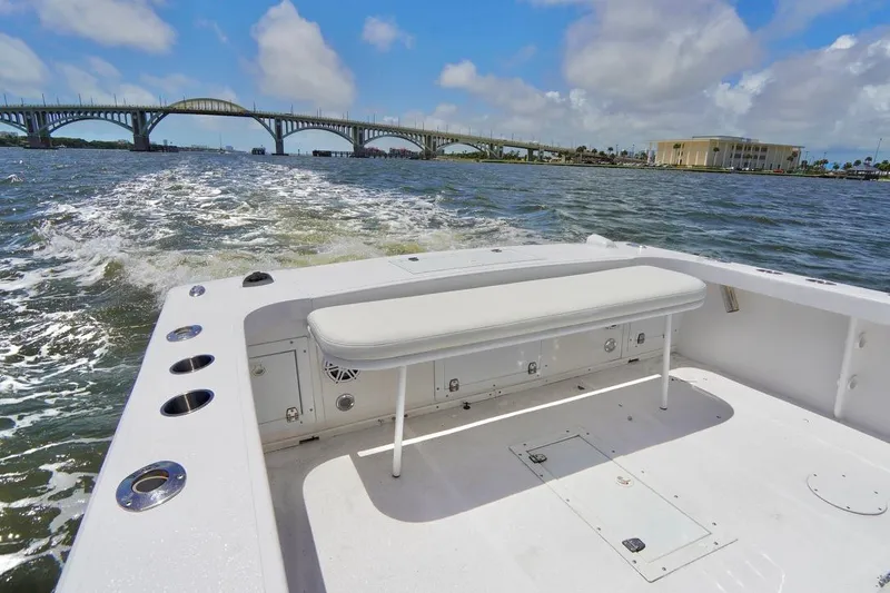 Slide: The Image of Ocean Runner 27 CC 1993 boat cruising under a bridge on a sunny day. - 20