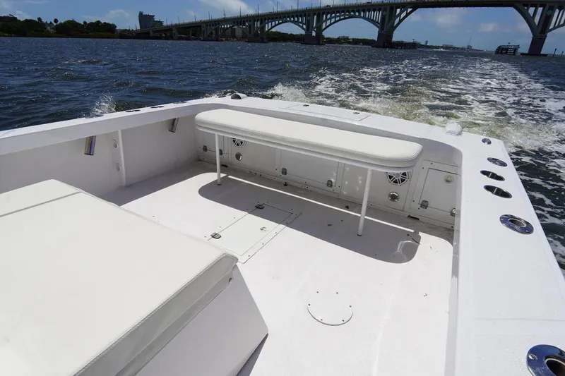 Slide: The Image of Ocean Runner 27 CC 1993 boat interior with white seating and bridge in background. - 21