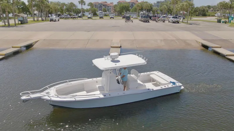 Slide: The Image of 1993 Ocean Runner 27 CC boat docked at a marina. - 4