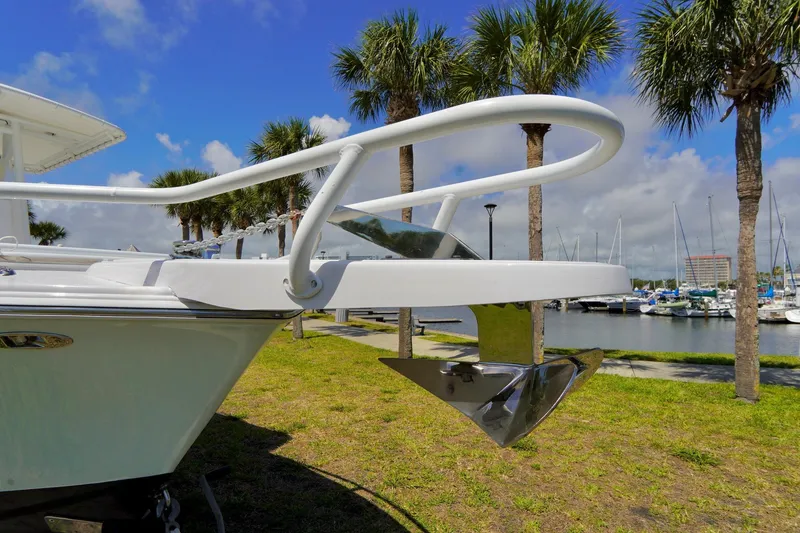 Slide: The Image of 1993 Ocean Runner 27 CC boat bow with anchor, docked near palm trees and marina. - 6