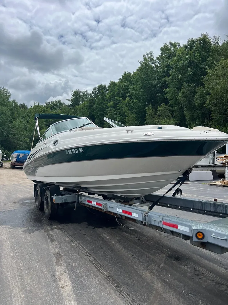 Slide: The Image of 2003 Sea Ray 270 boat on a trailer in a wooded area. - 4