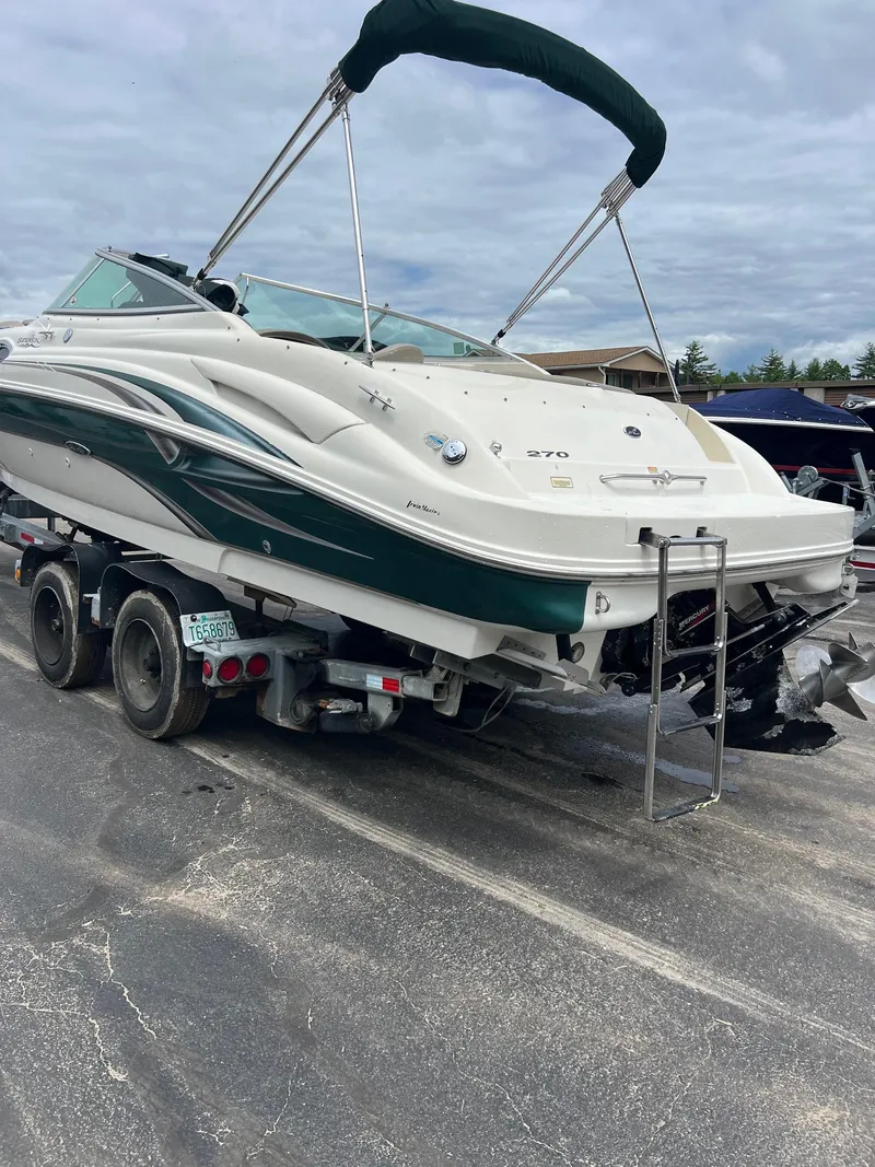 Slide: The Image of 2003 Sea Ray 270 boat on trailer, green and white, ready for transport. - 6