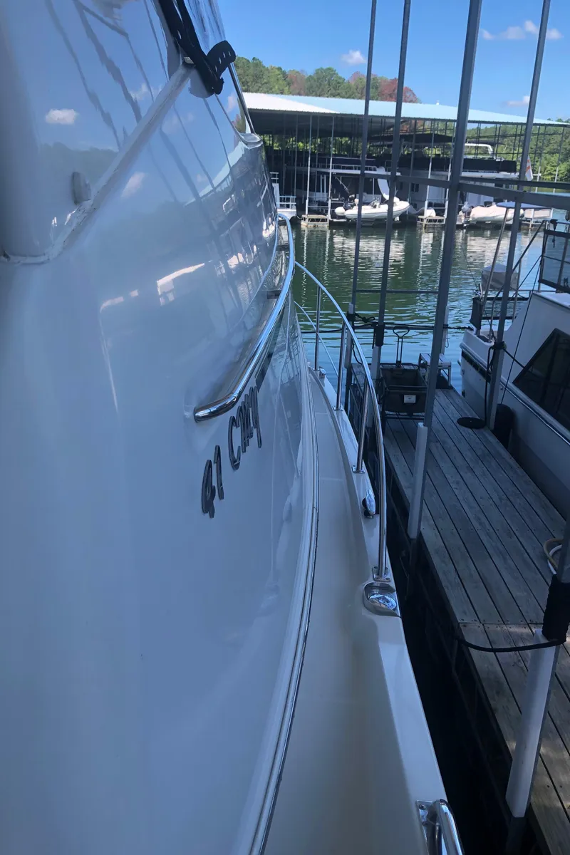 Slide: The Image of 2005 Carver 41 Cockpit Motor Yacht docked at a marina. - 17